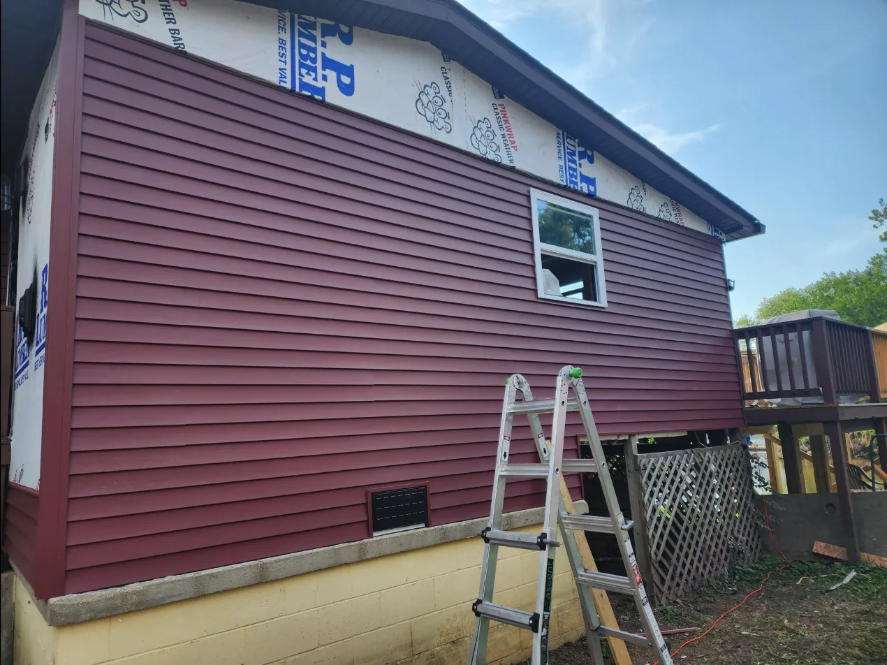 Siding job in progress by Helpful Home Solutions